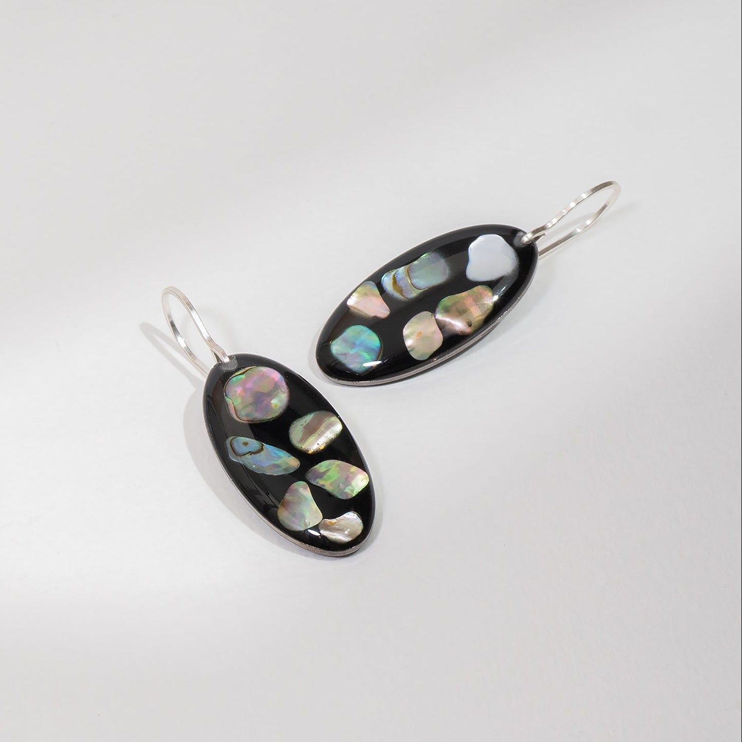 Midnight abalone shell oval drop earrings with genuine iridescent shell on dark background by Kate Koel
