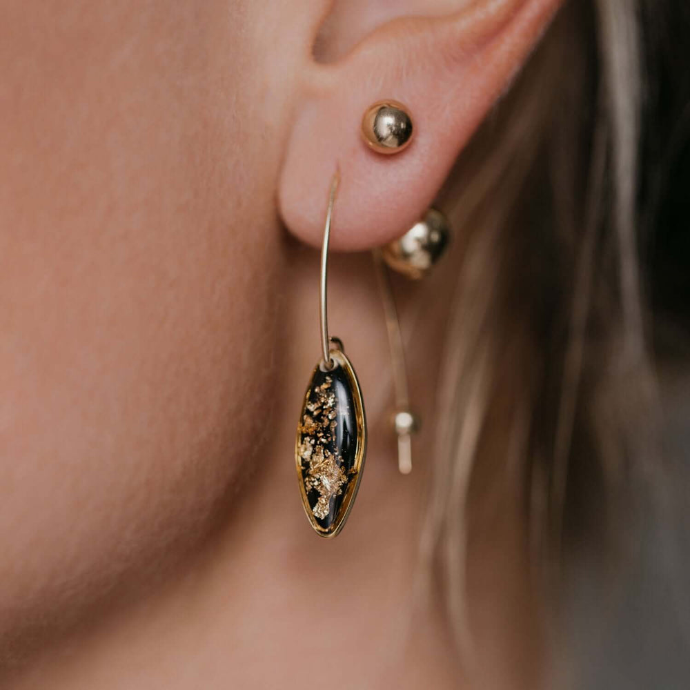 Delicate handcrafted minimalist flower dangle earrings in gold-filled metal by Kate Koel