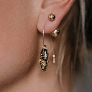 Delicate handcrafted minimalist flower dangle earrings in gold-filled metal by Kate Koel