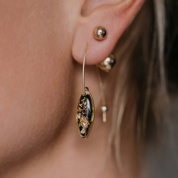 Delicate handcrafted minimalist flower dangle earrings in gold-filled metal by Kate Koel