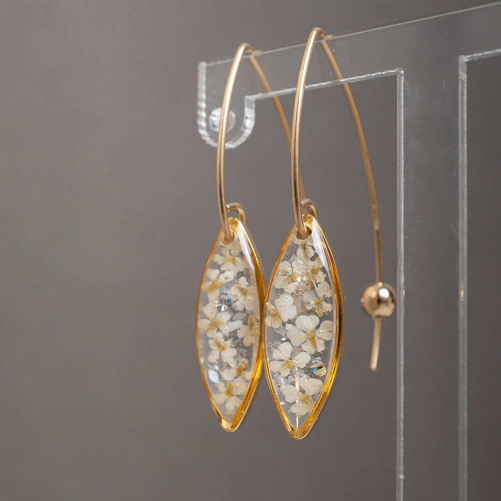 Delicate handcrafted minimalist flower dangle earrings in gold-filled metal by Kate Koel