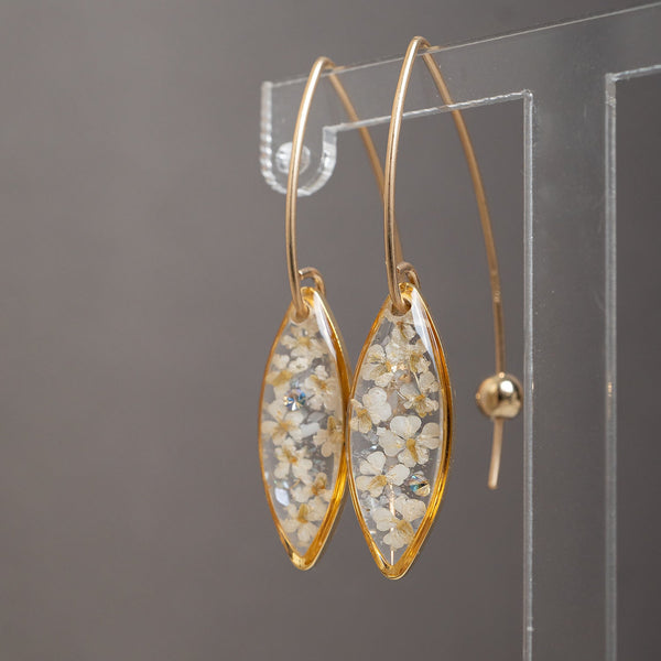 Delicate handcrafted minimalist flower dangle earrings in gold-filled metal by Kate Koel