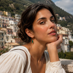 Woman with a scenic background of a hillside town.