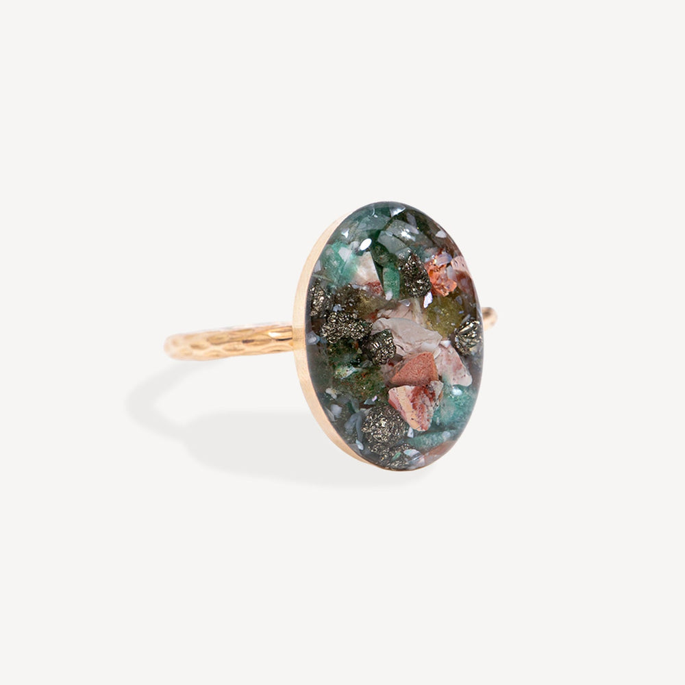 Ring with a colorful oval stone on a white background