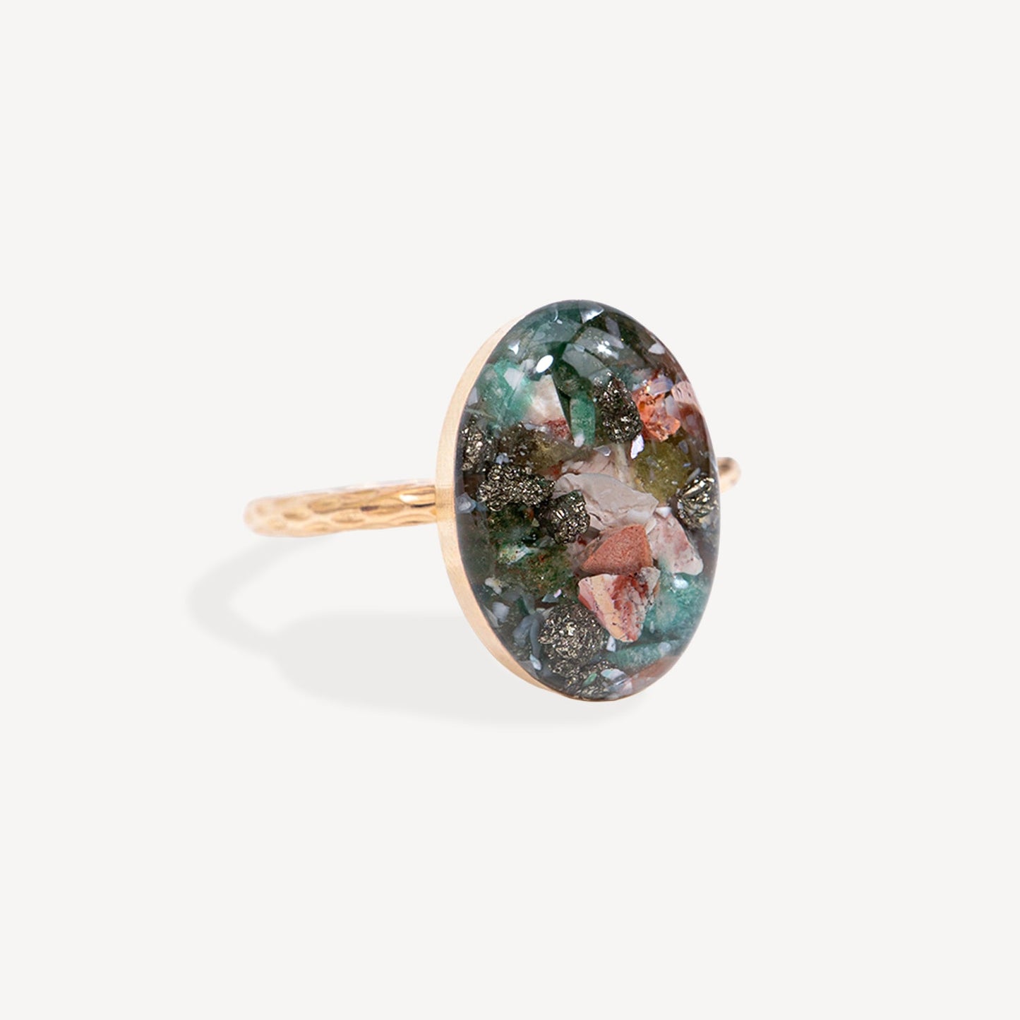Ring with a colorful oval stone on a white background