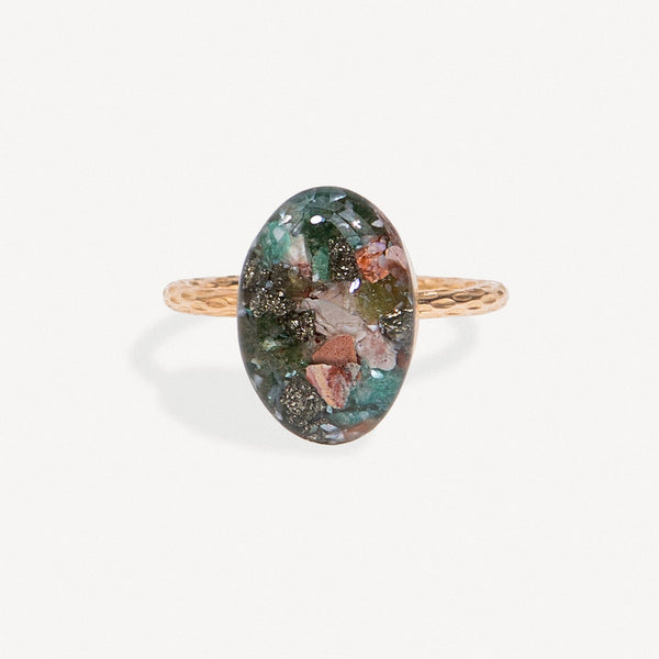 Ring with an oval gemstone on a white background