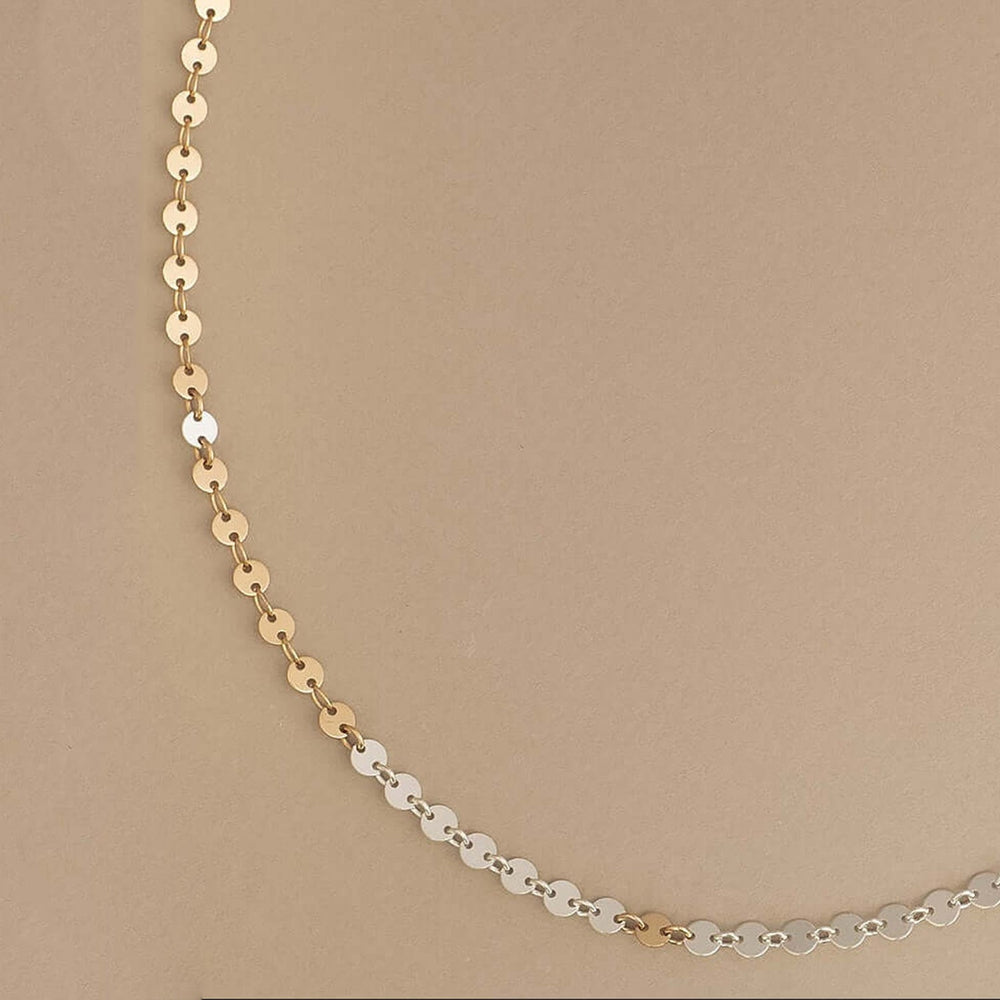 Gold beaded necklace on a white background
