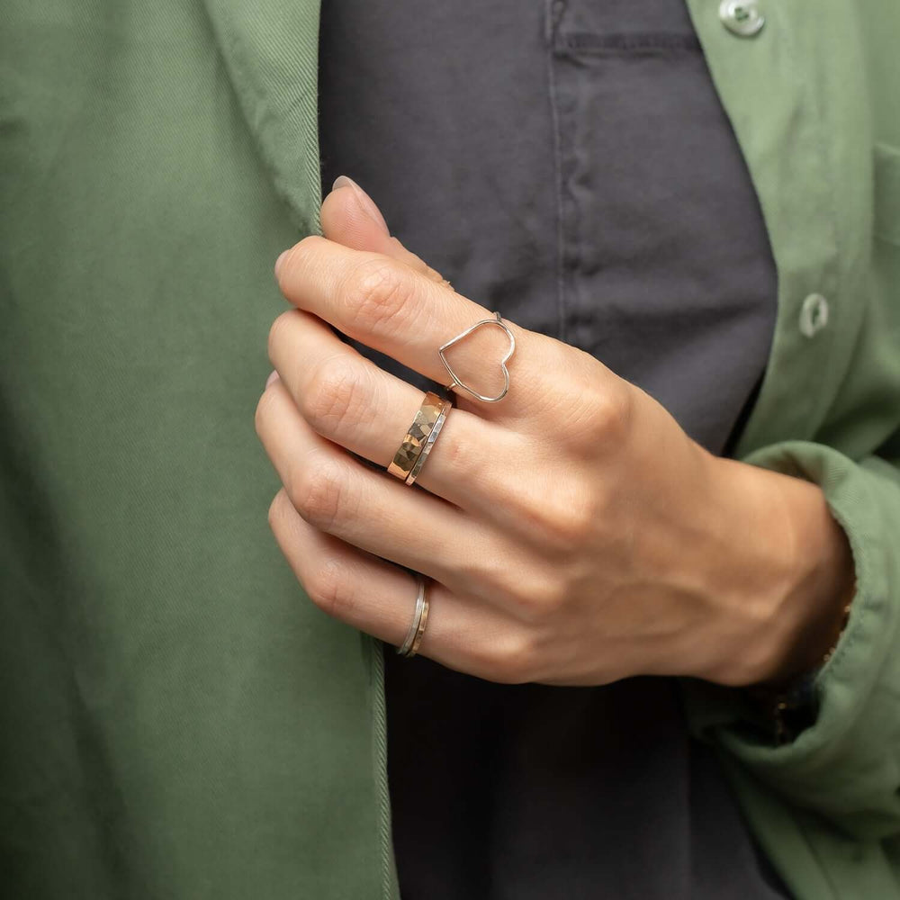 Two gold rings with a white background