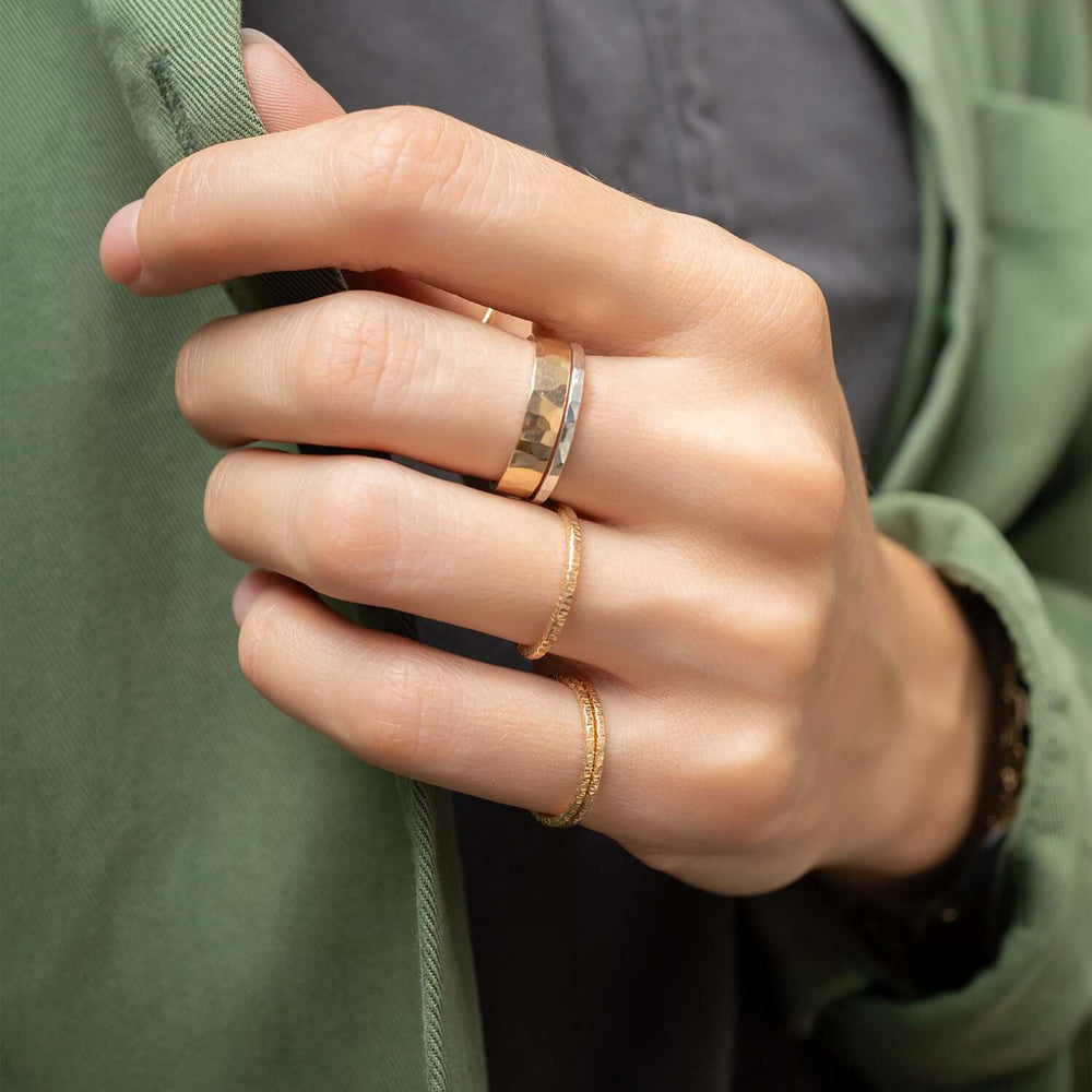 Two gold rings with a white background