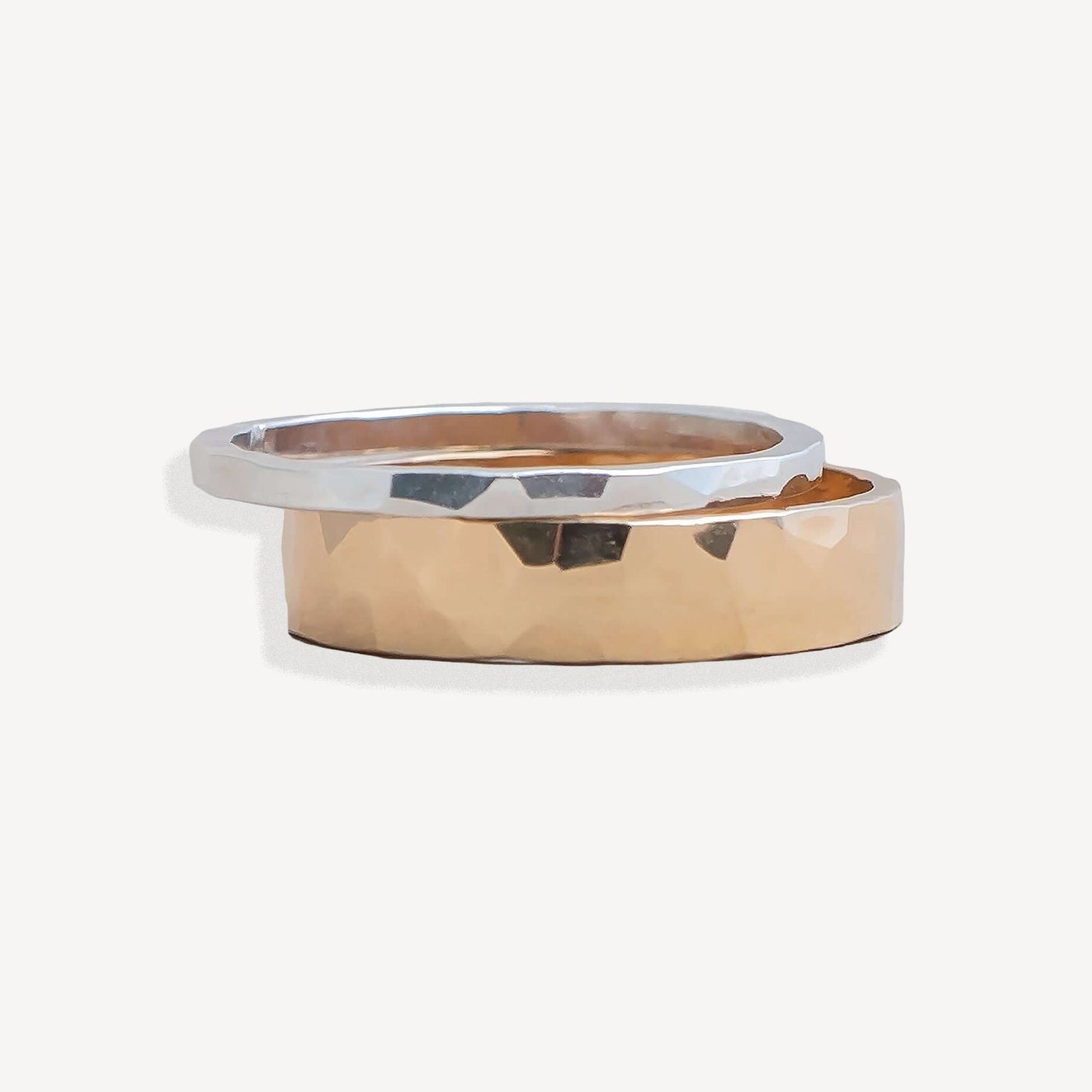 Two gold rings with a white background