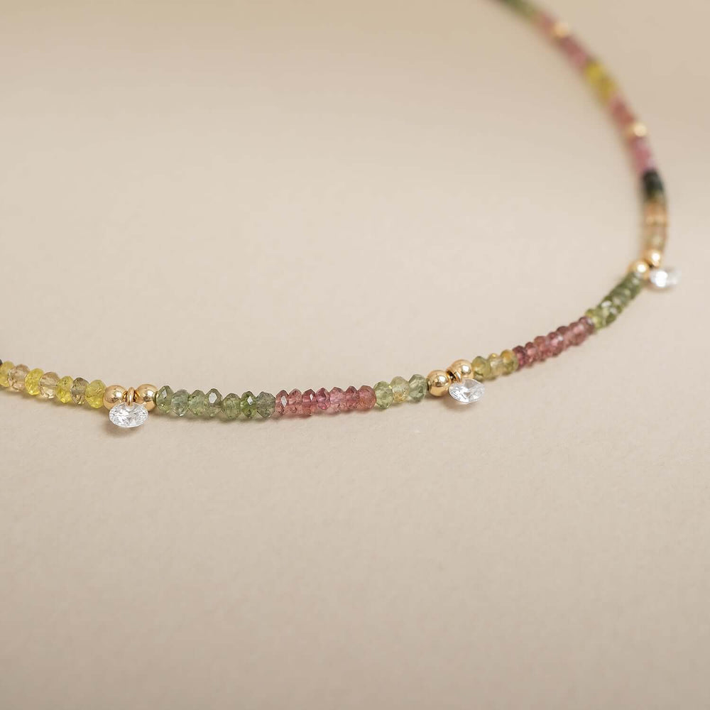 Necklace with multicolored beads on a beige background