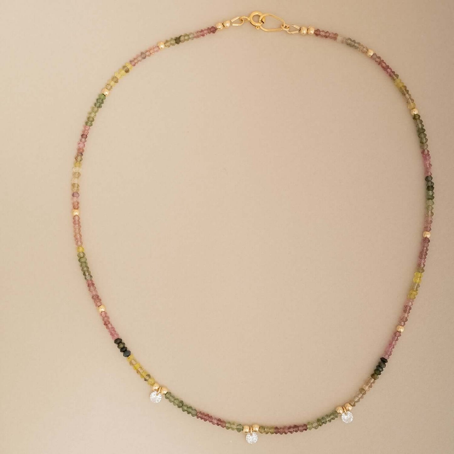 Necklace with multicolored beads on a beige background