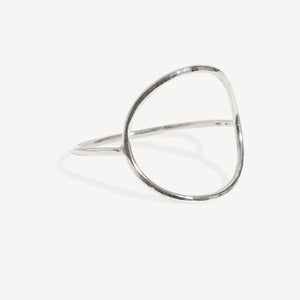 A minimalist silver open ring bangle with a polished, hammered texture, displayed on a clean off-white background.