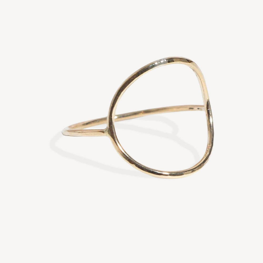 A minimalist gold open-ring cuff bangle with a polished finish, displayed on a clean off-white background.