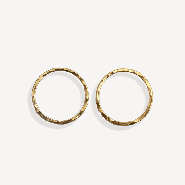 Pair of gold stud earrings on a white background