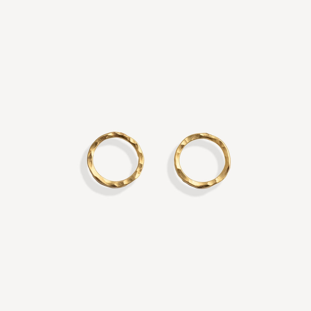 Pair of gold stud earrings on a white background