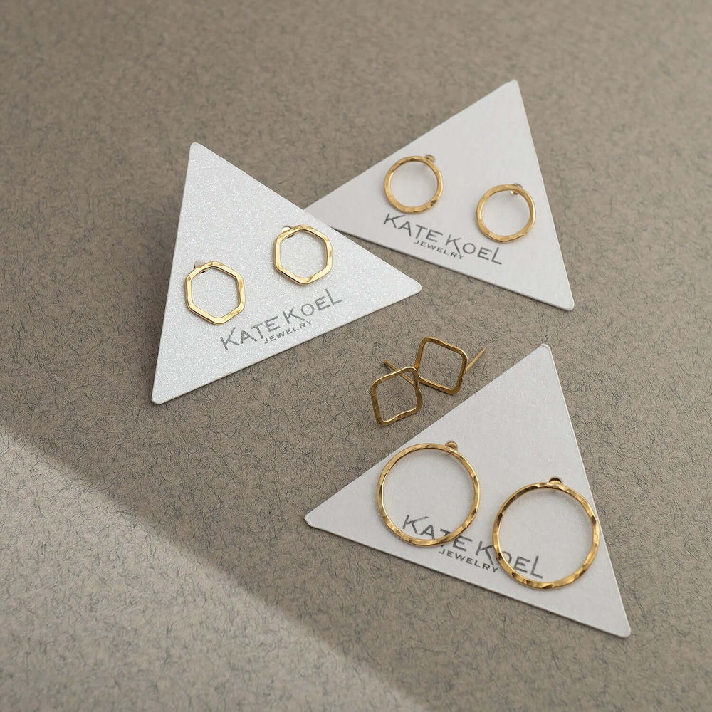 Gold square stud earrings on a white background