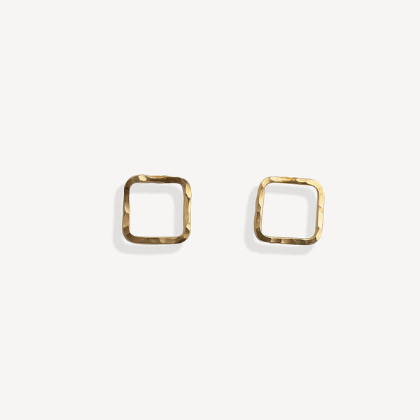 Gold square stud earrings on a white background