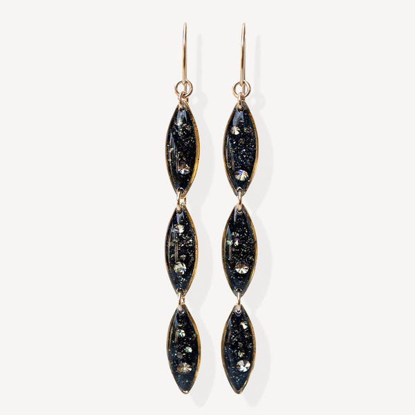 Pair of black and gold earrings on a white background