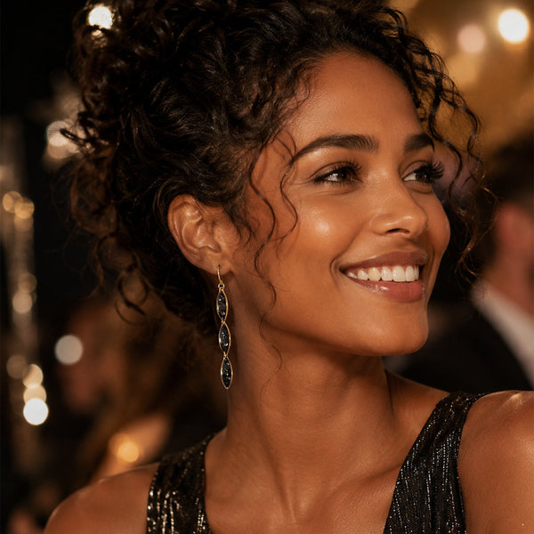 Woman with styled hair and earrings in a formal setting