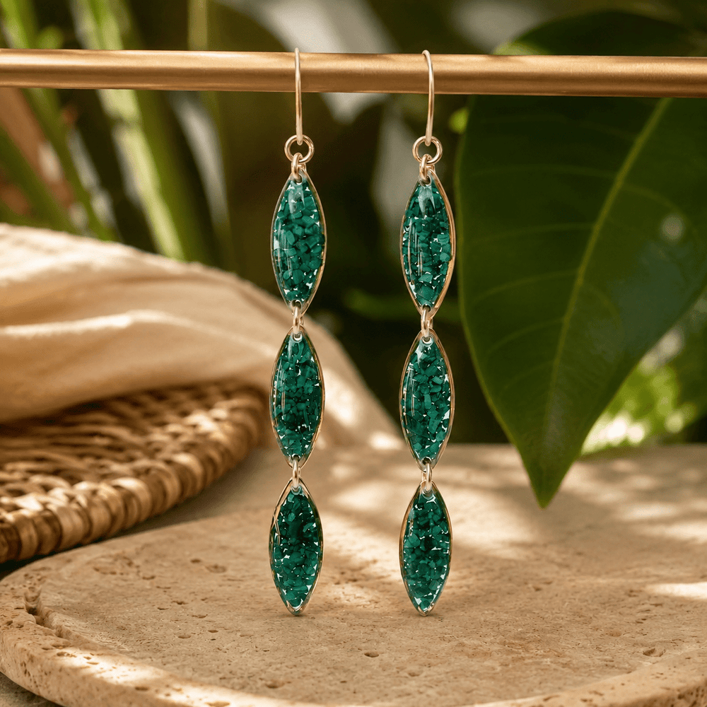 Green gemstone earrings on a white background