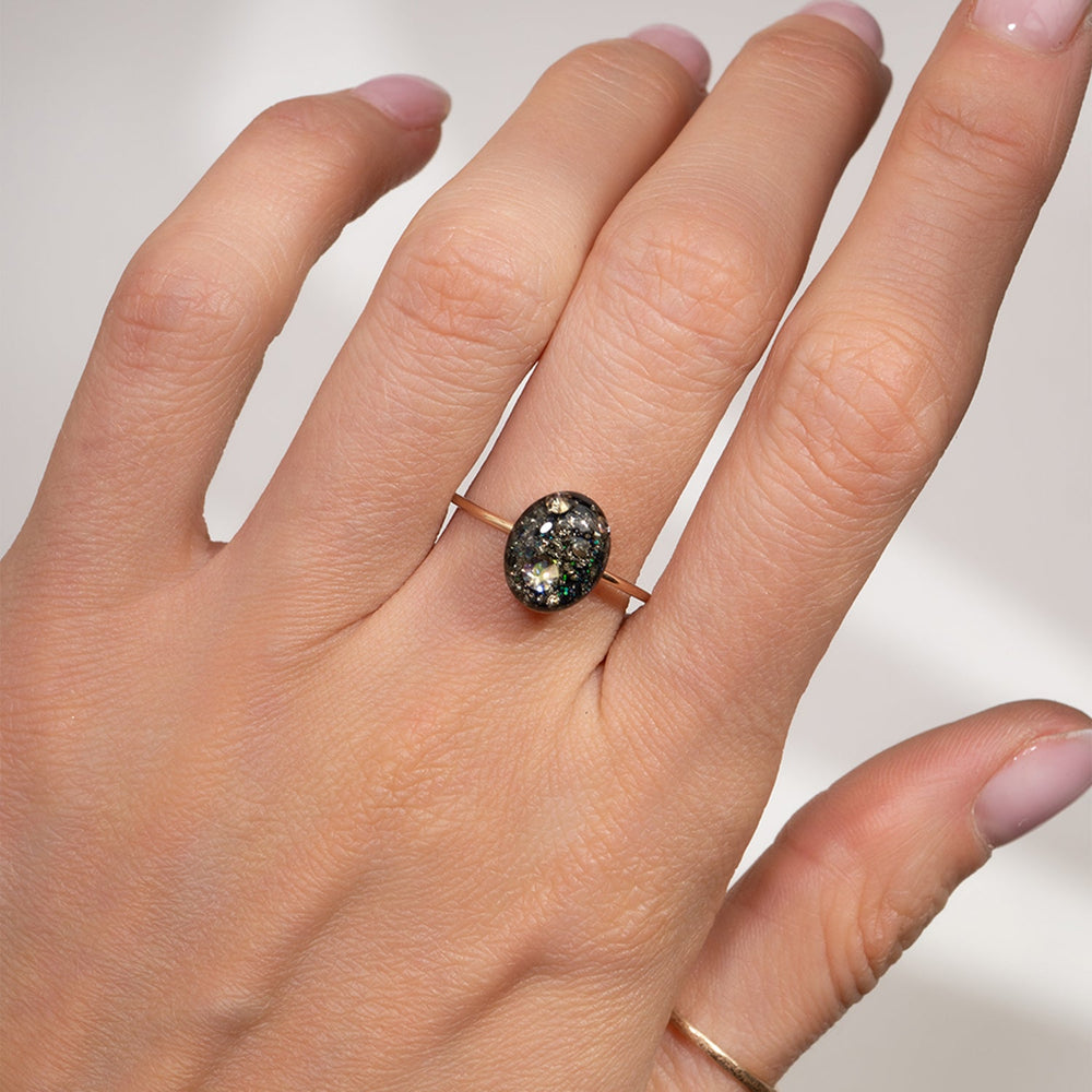 Ring with a black stone and clear gem on a white background