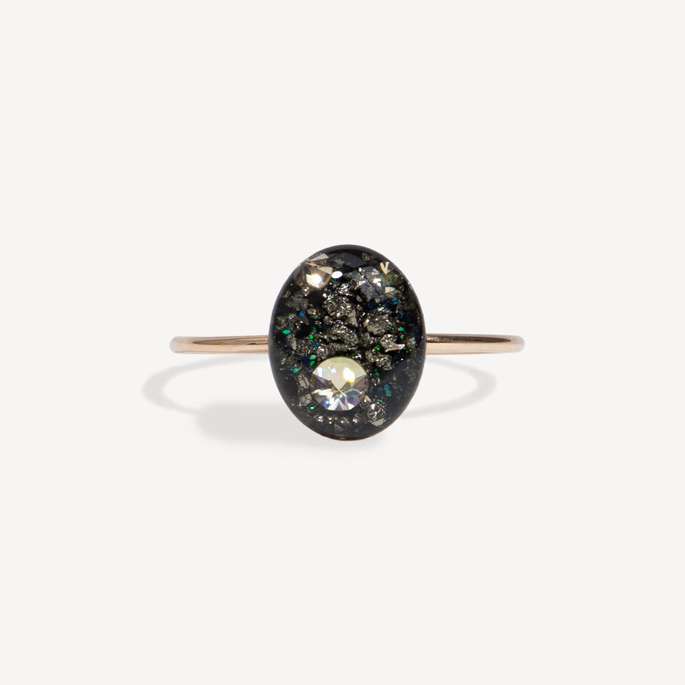 Ring with a black stone and clear gem on a white background