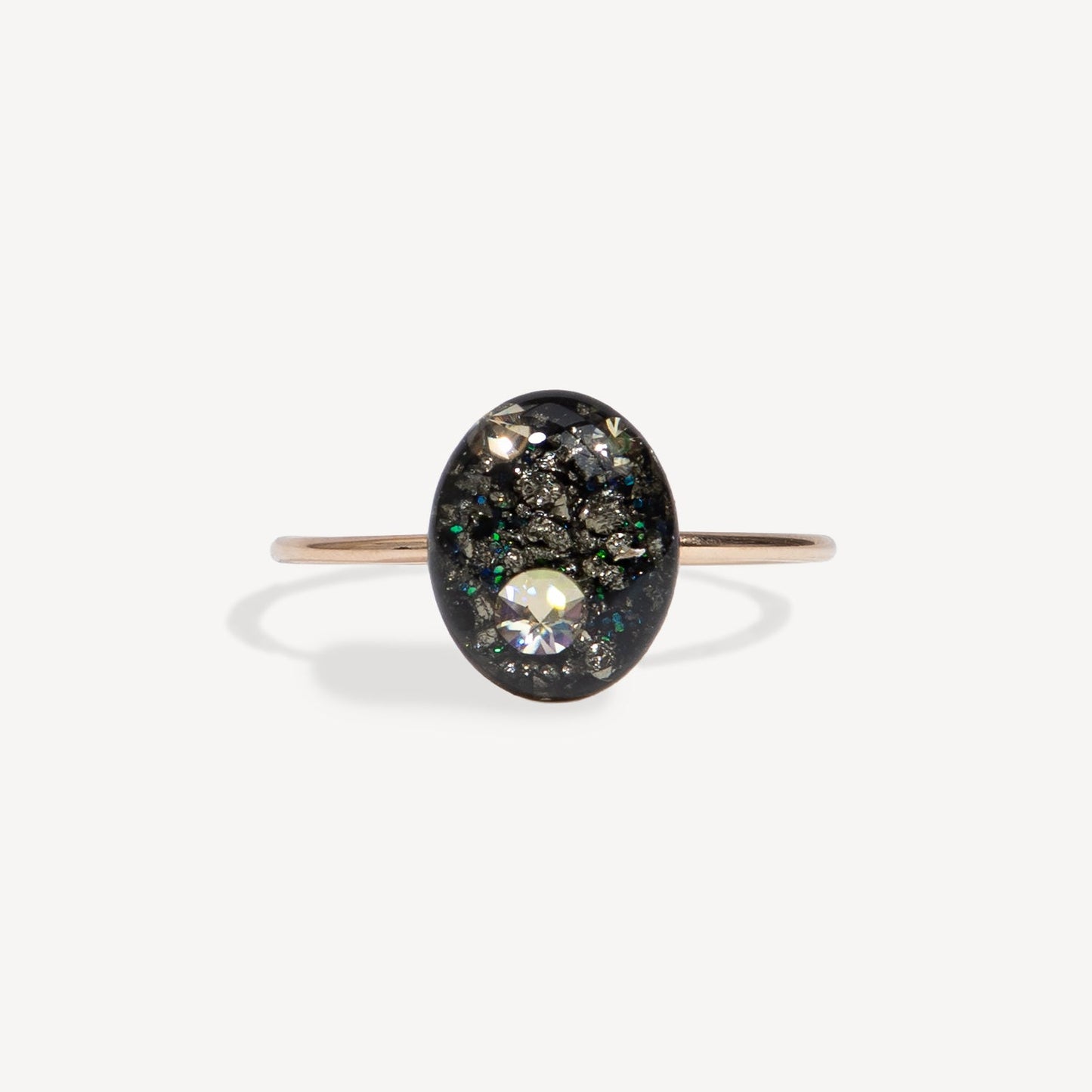 Ring with a black stone and clear gem on a white background