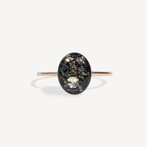 Ring with a black stone and clear gem on a white background