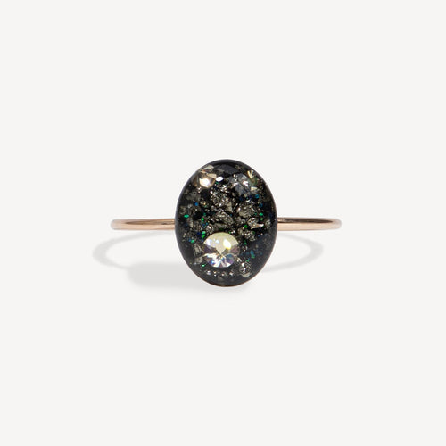 Ring with a black stone and clear gem on a white background