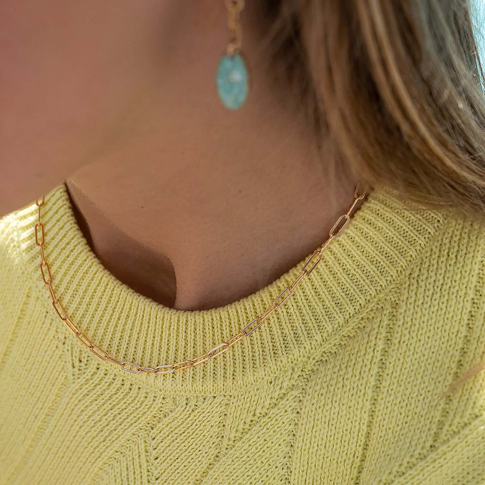 Gold chain necklace on a white background