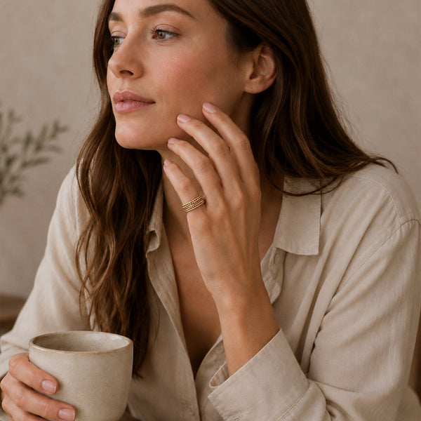 Woman holding a mug with a neutral background