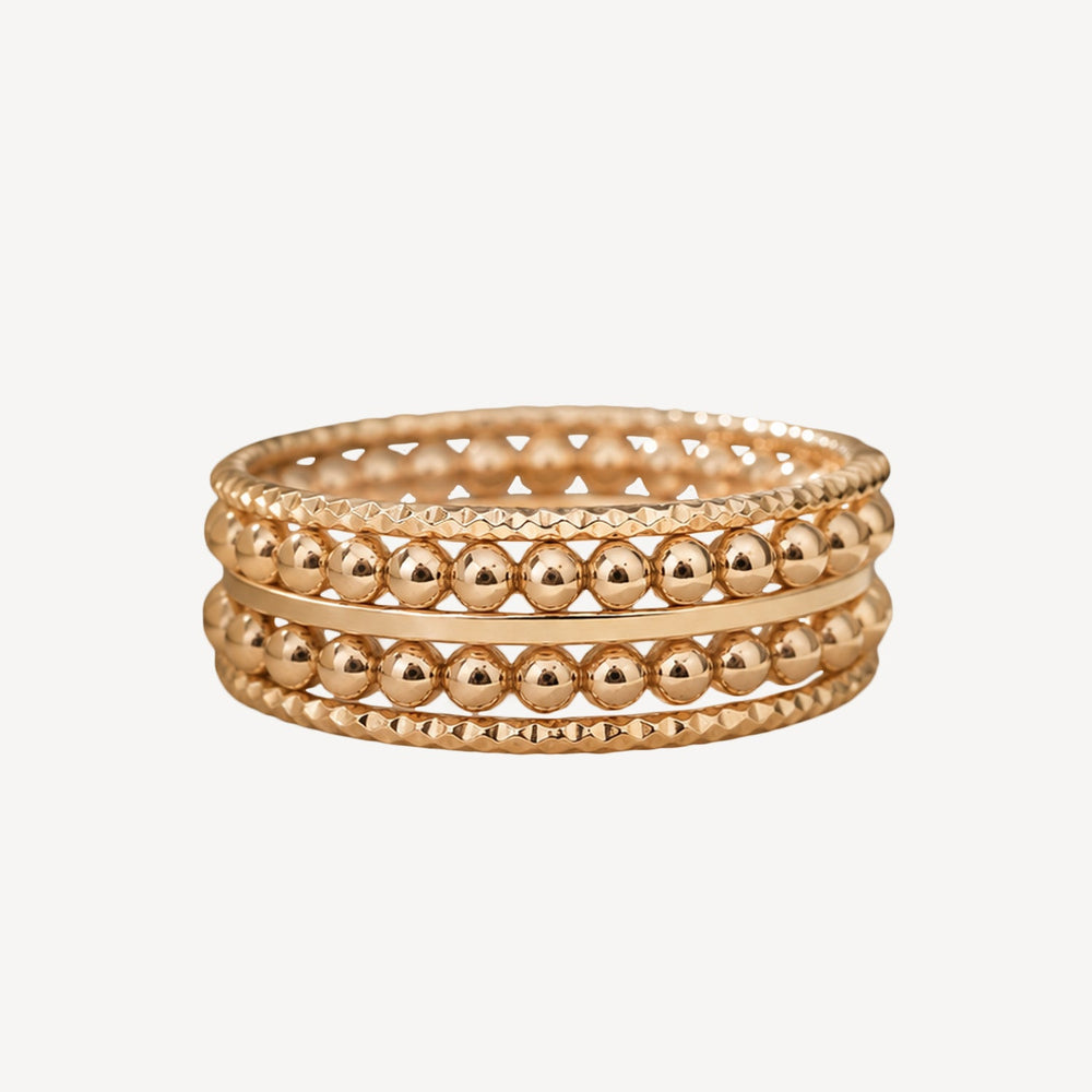 Hand wearing a gold ring with a blurred background