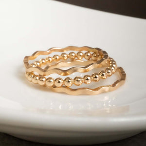 Handcrafted romantic stacking ring set with delicate floral-inspired gold-filled bands by Kate Koel