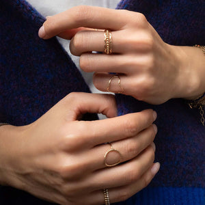 Handcrafted romantic stacking ring set with delicate floral-inspired gold-filled bands by Kate Koel