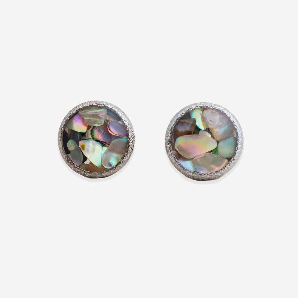 Pair of round earrings with gold frame and multicolored stone center on a white background
