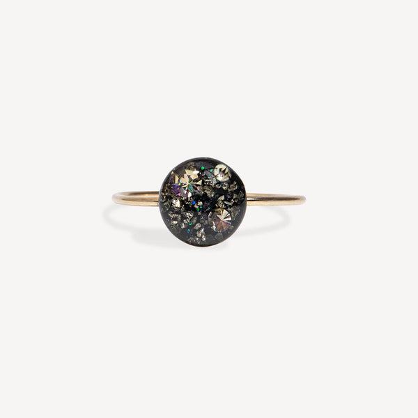 Gold ring with a central stone on a white background