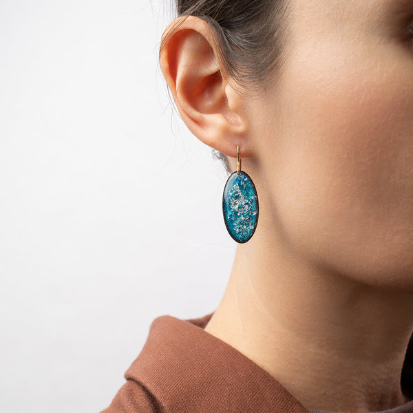 Handcrafted silver glow oval drop earrings with polished silver pendant and textured gold-filled ear wire by Kate Koel