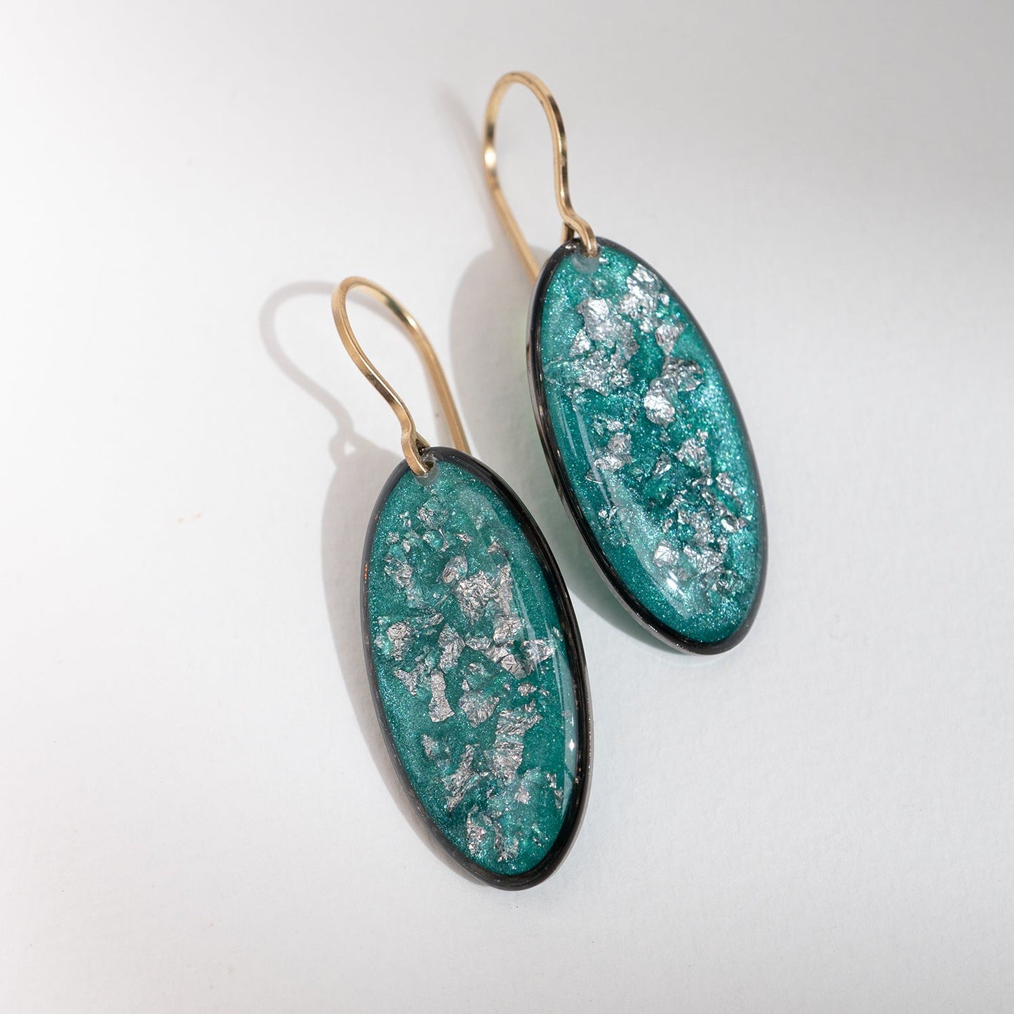 Handcrafted silver glow oval drop earrings with polished silver pendant and textured gold-filled ear wire by Kate Koel