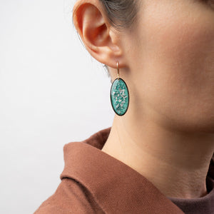Handcrafted silver glow oval drop earrings with polished silver pendant and textured gold-filled ear wire by Kate Koel