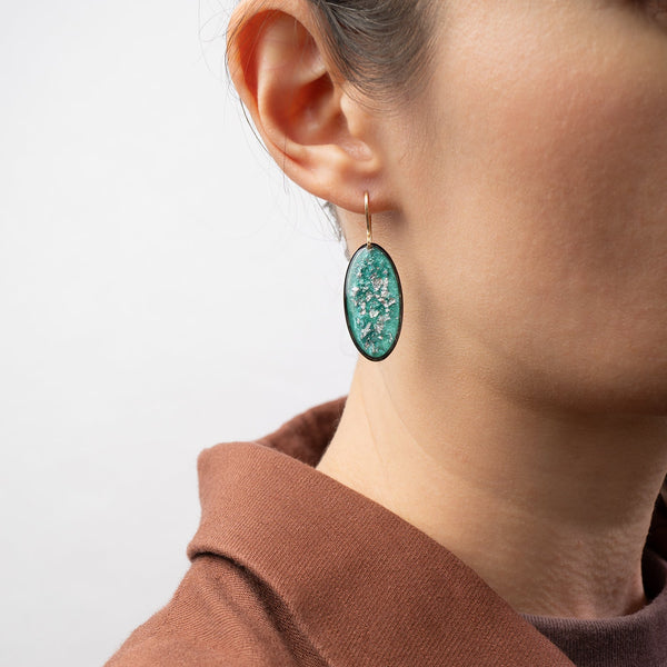 Handcrafted silver glow oval drop earrings with polished silver pendant and textured gold-filled ear wire by Kate Koel