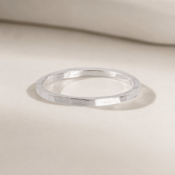 Silver ring on a beige background