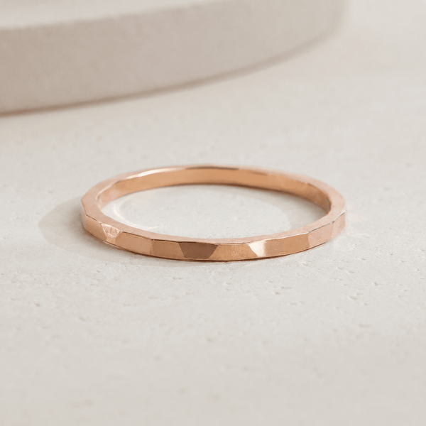 Rose gold bangle on a light beige background