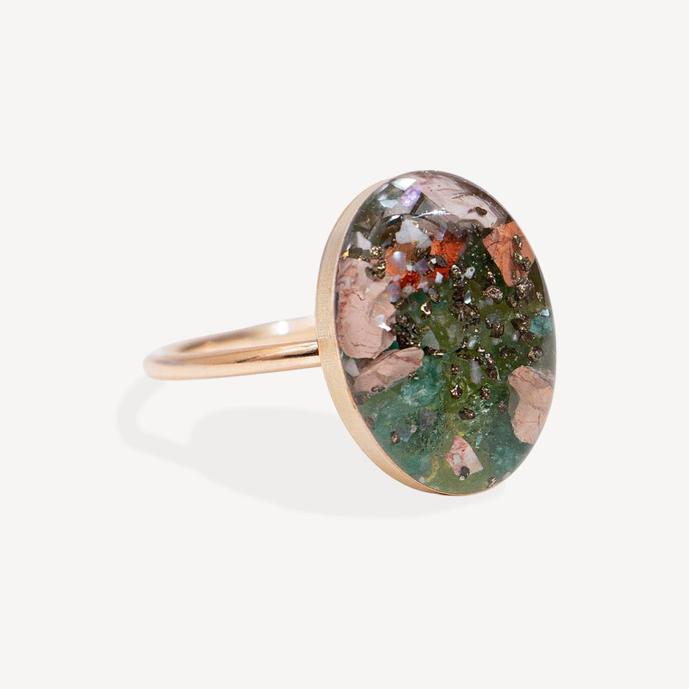 Ring with a multicolored stone on a white background