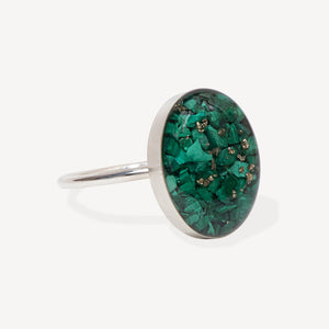 Silver ring with a green gemstone on a white background