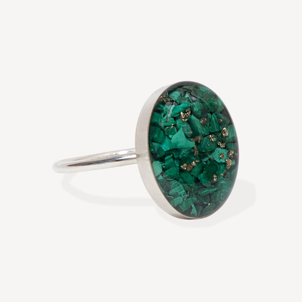 Silver ring with a green gemstone on a white background