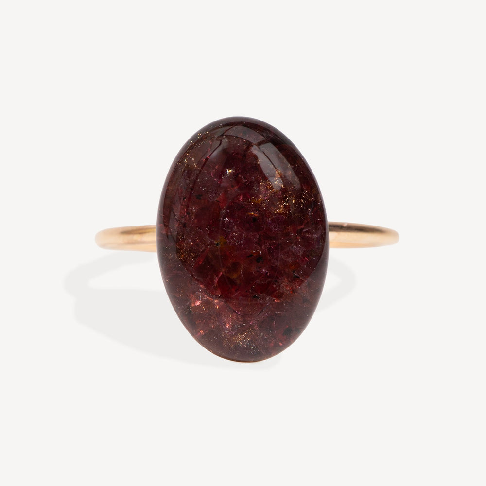 Ring with a large brown oval stone on a white background
