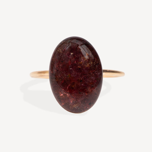 Ring with a large brown gemstone on a white background