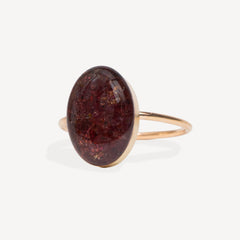 Ring with a large brown oval stone on a white background