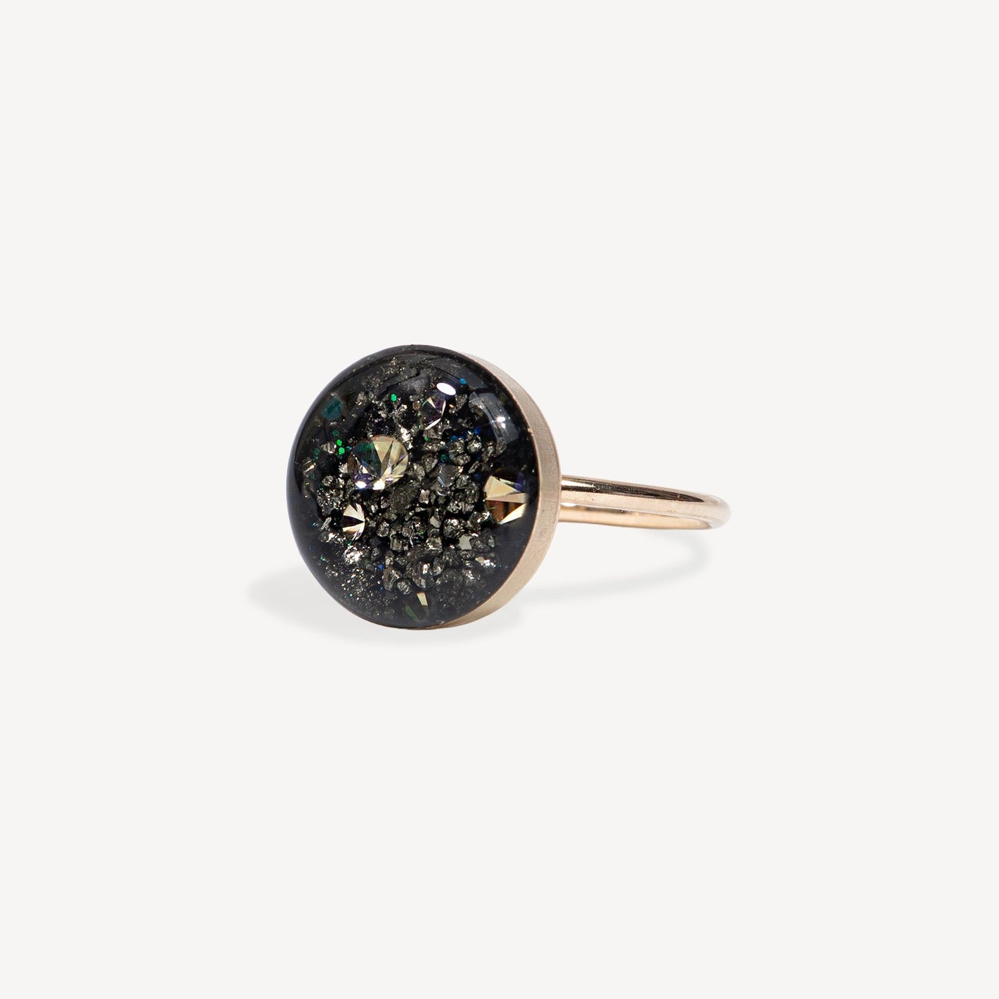 Silver ring with a textured square stone on a light gray background